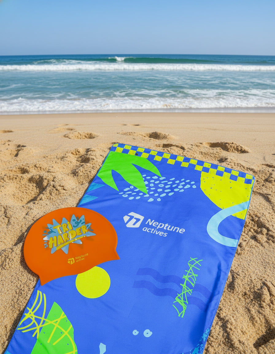 Neptune Actives swim cap and towel with colorful design on a white background